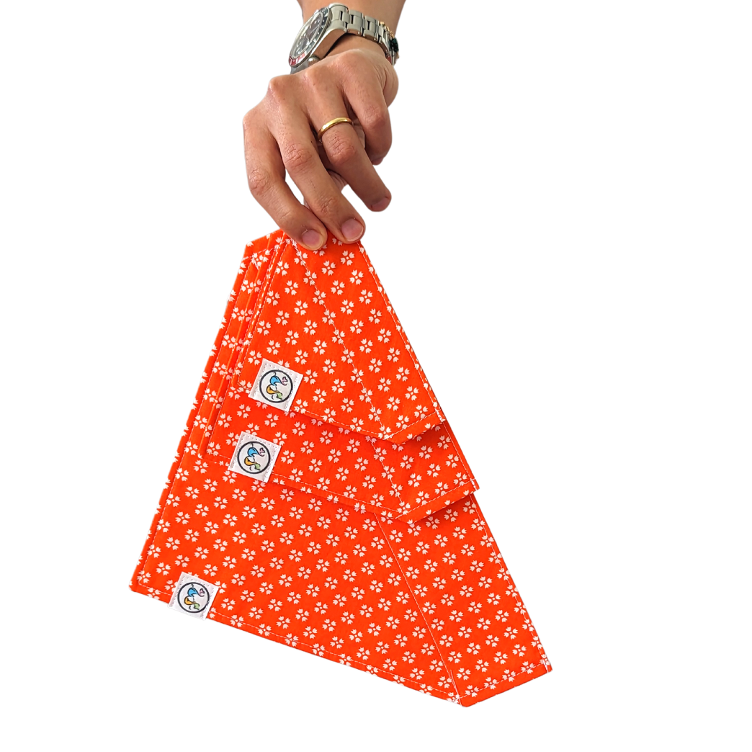 Image of three bandanas in different sizes (small, medium, and large) showcasing the bright orange with white floral design for size comparison.