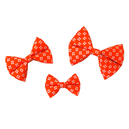 Image showcasing our Bright Orange with White Floral Bow Ties in three sizes: Small, Medium, and Large, providing size comparison for reference.