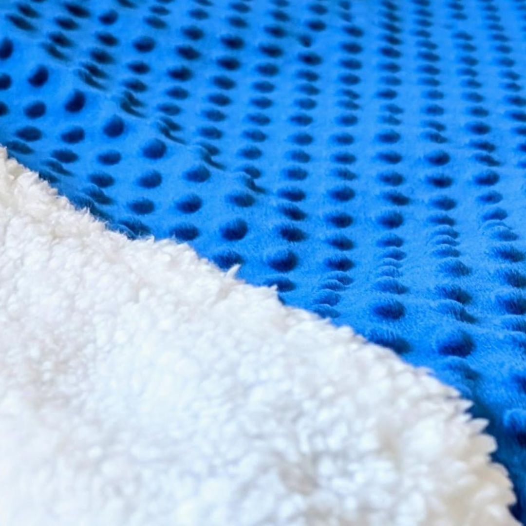 Royal blue pet sleeping bag close up of faux sherpa and soft minky fabric
