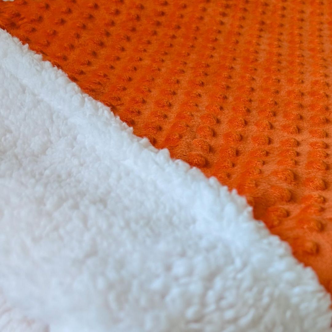 Close up of Vibrant orange burrow bed for cats and small dogs up to 50 lbs.