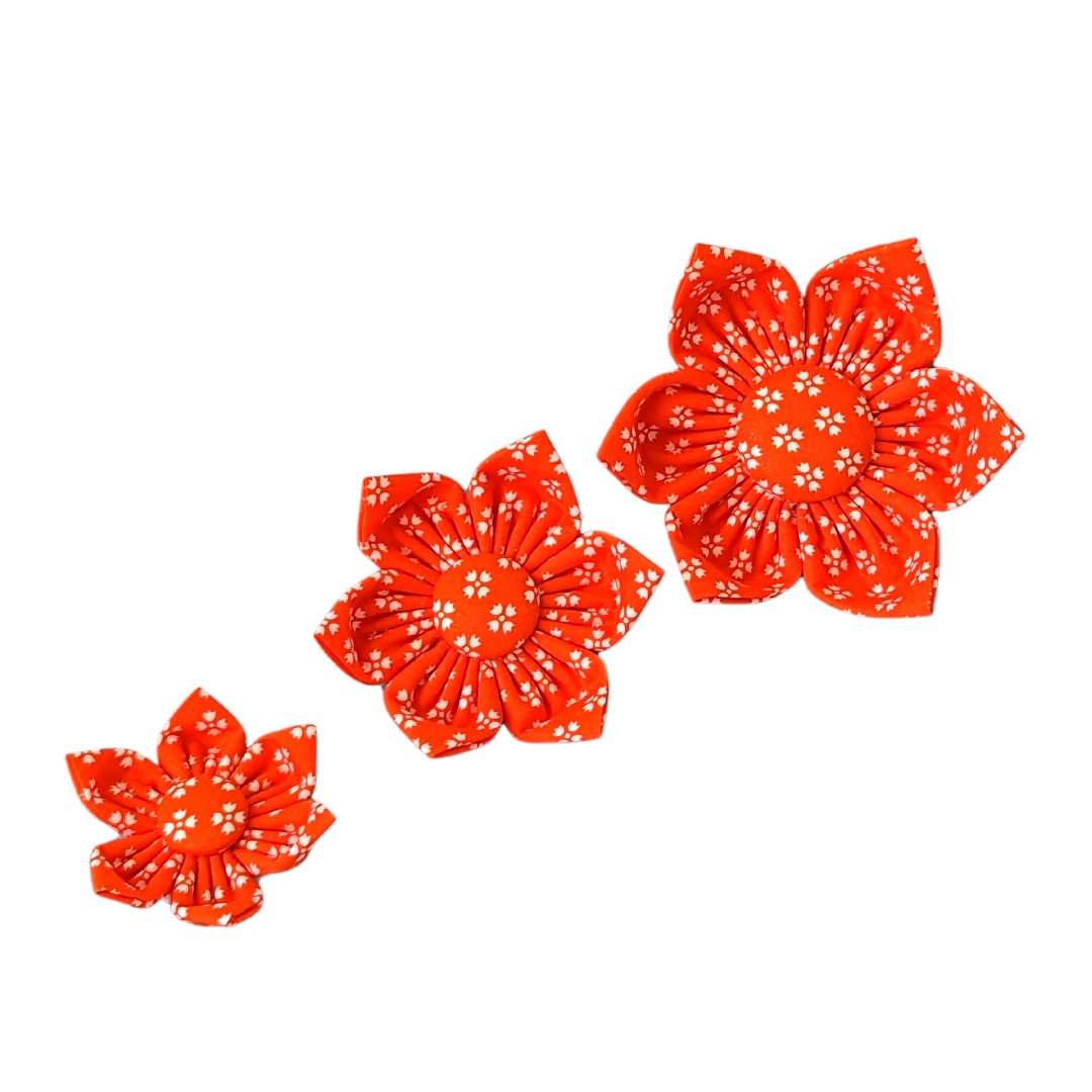 Image showcasing the size comparison of three Bright Orange with Whimsical White Floral Kanzashi Flowers: Small, Medium, and Large.